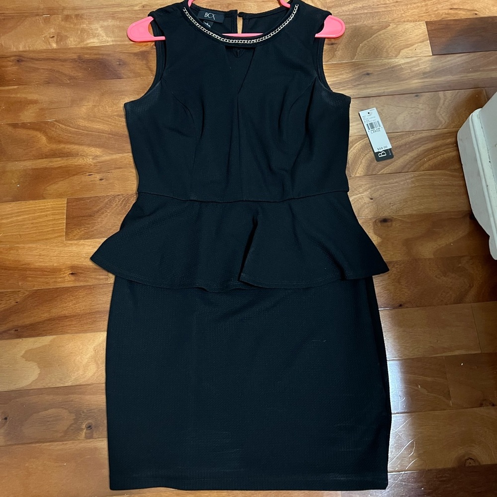 Black peplum dress with gold accent neckline
